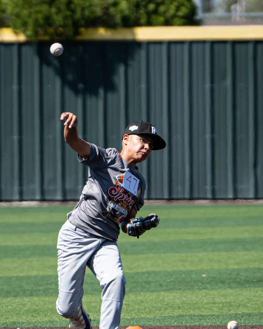 Young TX Torque pitcher delivering a pitch on the field